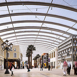A large glass dome with people walking around.