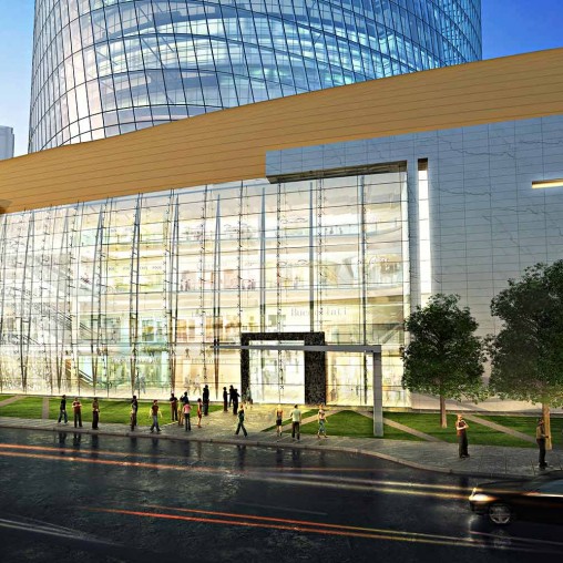 A large glass building with people walking around.