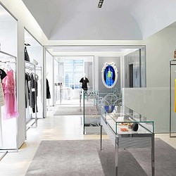 A room with a glass table and a glass door with a glass window.