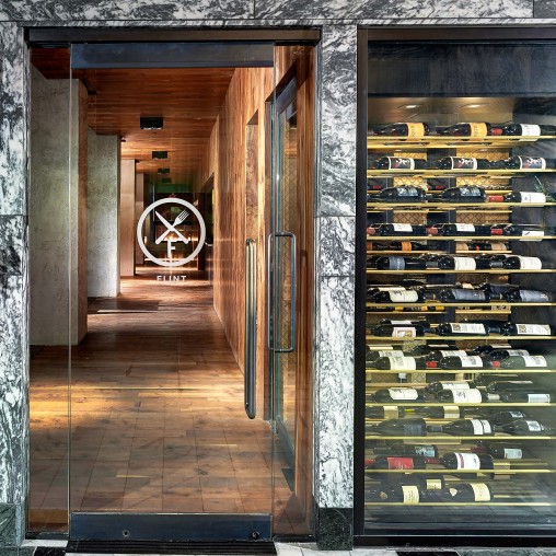 A room with shelves of wine.