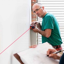 A man painting a wall.