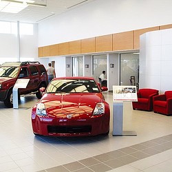 A red sports car in a showroom.