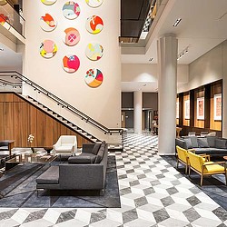 A room with a staircase and chairs.