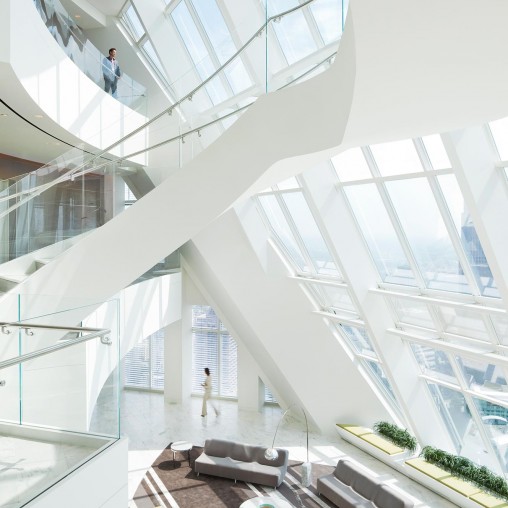 A room with glass walls and a couple of people standing in it.