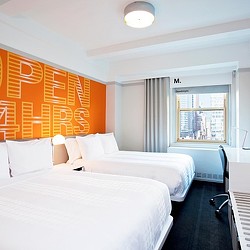 A hotel room with two beds.