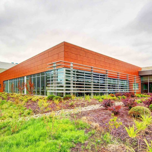 A building with a garden in front.