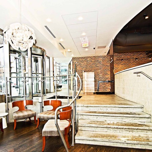A room with a staircase and chairs.