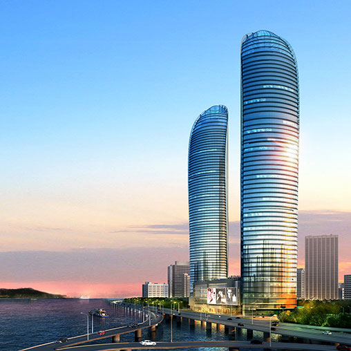 A couple of tall buildings by the water.