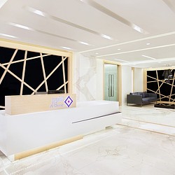 A room with a white bed and a window.