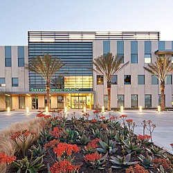 A building with a fountain in front.