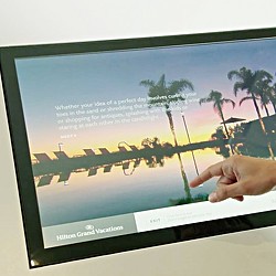 A hand holding a tablet.
