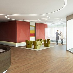 A person and a child standing in a room with a large display of green and yellow objects.