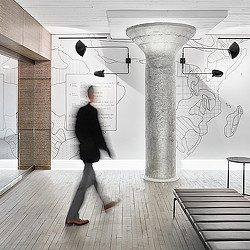 A person walking down a hall.