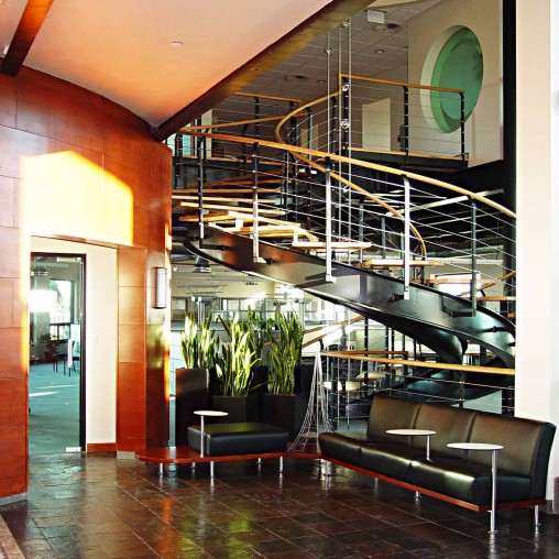 A room with a staircase and a glass wall.