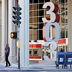 A person standing next to a traffic light.