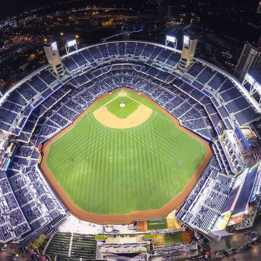 A large stadium with a green field.