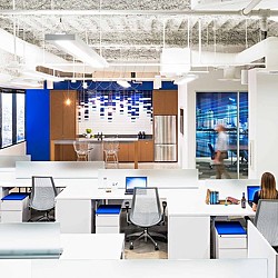 A room with a large screen and chairs.