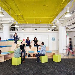 A group of people sitting on benches.