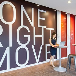 A person standing in front of a sign.