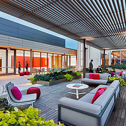 A modern looking building with a few people and a table.