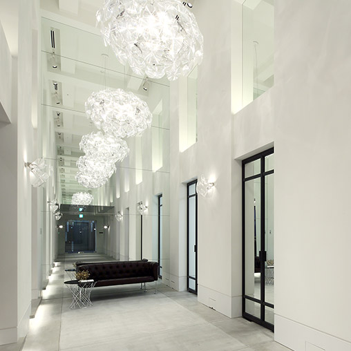 A room with a chandelier and a couch.