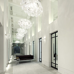 A room with a chandelier and a couch.