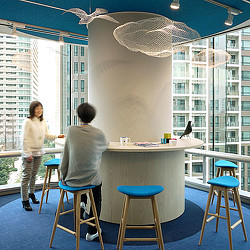 A couple of women sitting at a table with a bird on it.