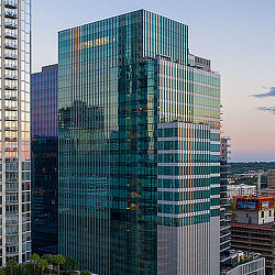 A tall building with many windows with Inland Steel Building in the background.