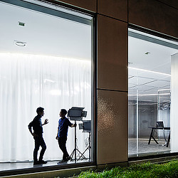 A few men standing in front of a window.