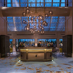 A large room with a large chandelier and a large bar.