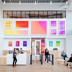 A person standing in front of a display of pictures.