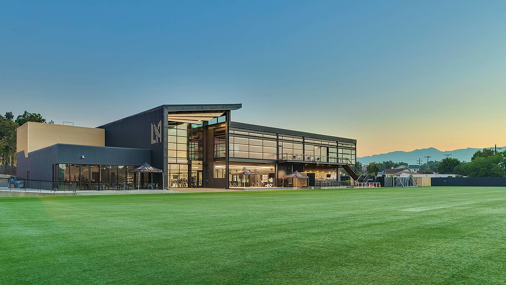 A building with a grass field.