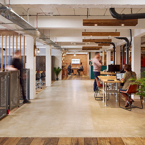 People in a room with tables and chairs.