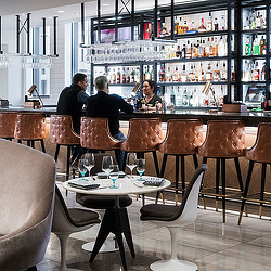 A group of people sitting at a table in a restaurant.