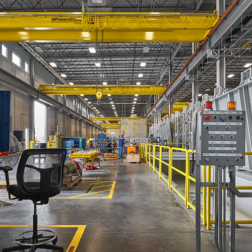 A large warehouse with yellow and black machines.