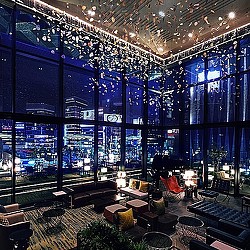 A room with a large window and a large group of chairs.