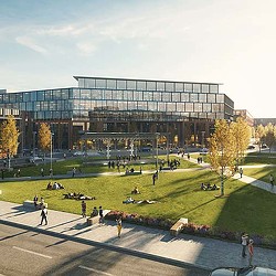 A large building with people walking around.