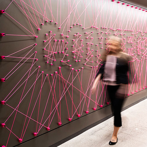 A person standing in front of a wall of lights.