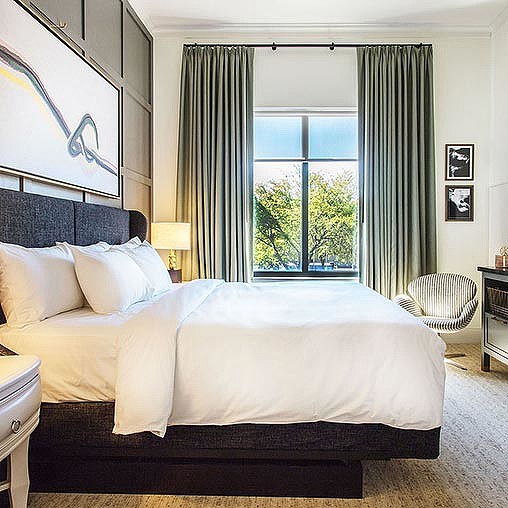 A bed with a large window.