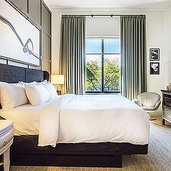 A bed with a large window.