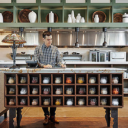 A person standing behind a counter.
