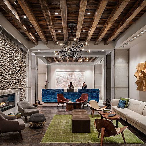 A living room with a chandelier and a couch.