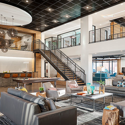 A modern looking living room with a staircase.