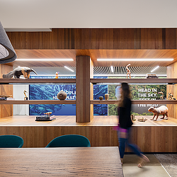 A person walking on a wooden floor.