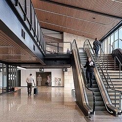 People with luggage in a building.