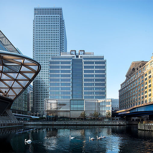 A group of buildings next to a body of water.