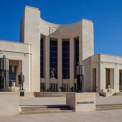A building with a statue in front.