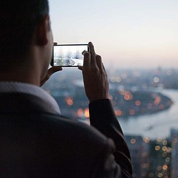A man taking a picture of a city.