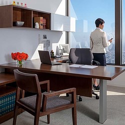A person standing next to a desk.