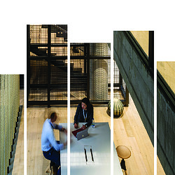 A woman looking at a man sitting on a table.